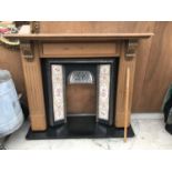AN ORNATE FIRE PLACE WITH MARBLE HEARTH, WOODEN FIRE SURROUND AND DECORATIVE FILED FIRE PLACE