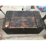 A VINTAGE WOODEN TRUNK WITH GALVANISED LINER, NAMED "L I HUNT, CEYLON"