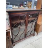 A 19TH CENTURY MAHOGANY AND INLAID TWO DOOR GLAZED BOOKCASE ON BRACKET FEET WITH DENTIL CORNERS,