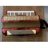 A VINTAGE ACCORDION IN A CARRY CASE