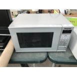 A SILVER PANASONIC MICROWAVE BELIEVED IN WORKING ORDER BUT NO WARRANTY