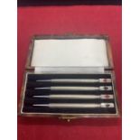 A SET OF FOUR STERLING SILVER BRIDGE PENCILS WITH CARD SUIT MOTIFS, IN A PRESENTATION BOX