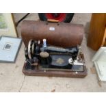 A CASED VINTAGE SINGER SEWING MACHINE WITH KEY