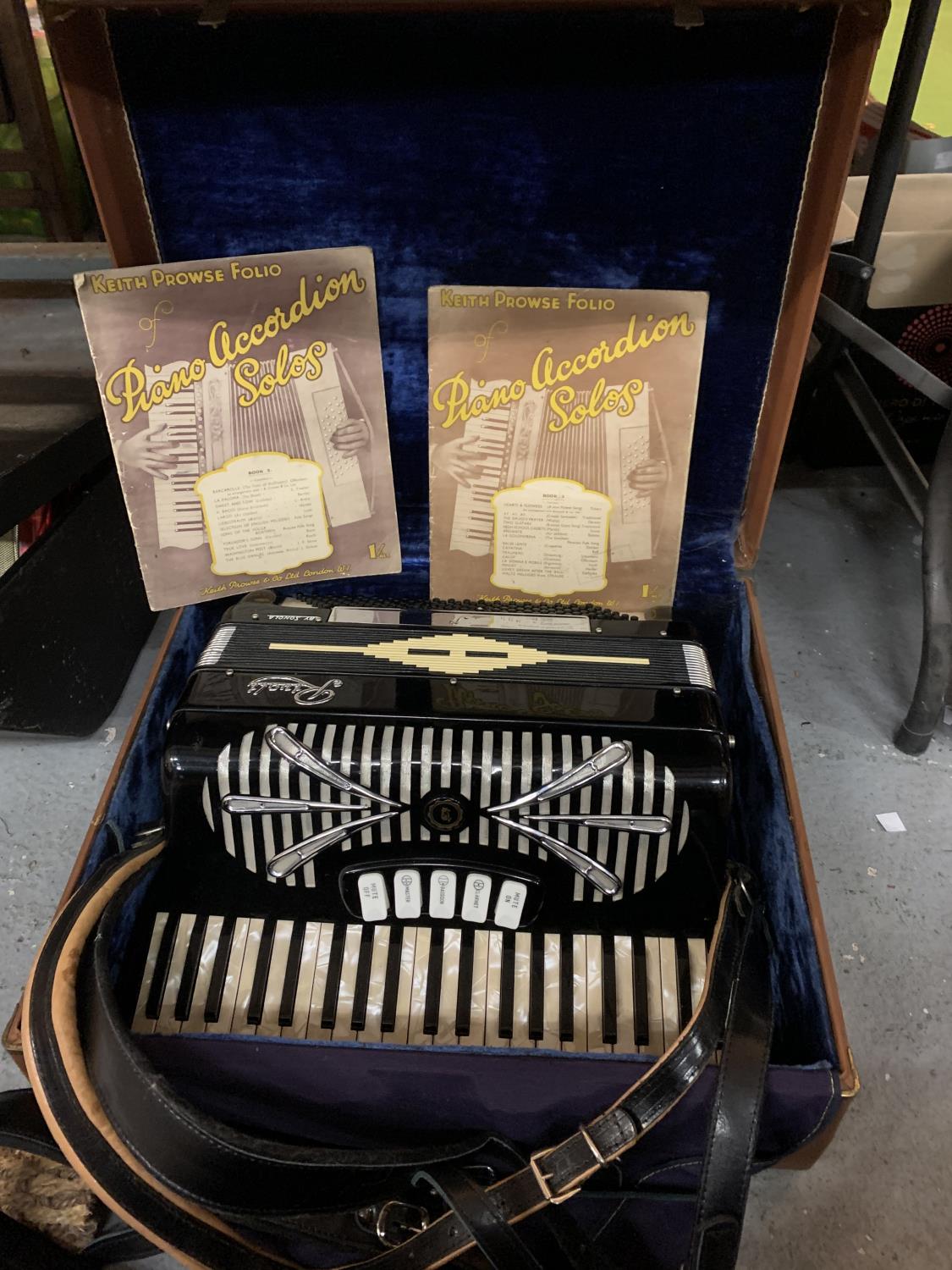 A VINTAGE ACCORDION IN A LEATHER EFFECT CARRY CASE