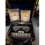 A VINTAGE ACCORDION IN A LEATHER EFFECT CARRY CASE