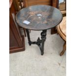 A VICTORIAN ROUND EBONISED OCCASIONAL TABLE, 21" DIAMETER, ON TURNED BASE, THE TOP HAVING INDISTINCT