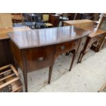 A BOW FRONT MAHOGANY SIDEBOARD ON TAPERED SUPPORTS WITH TWO DOORS AND ONE DRAWER