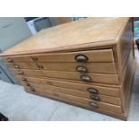 AN OAK PLAN CHEST WITH SIX DRAWERS