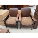 TWO OAK AND STUDDED LEATHER PARLOUR ARMCHAIRS ON BALL AND CLAW FEET