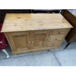A MODERN PINE SIDE CABINET ENCLOSING THREE DRAWERS AND TWO CUPBOARDS, 42" WIDE