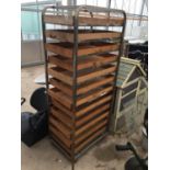 A VINTAGE BAKER'S RACK WITH BREAD TRAYS