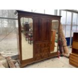 AN EDWARDIAN MAHOGANY DOUBLE MIRROR-DOOR WARDROBE, WITH THREE DRAWERS AND CUPBOARD TO CENTRE