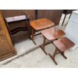 A MAHOGANY MAGAZINE RACK TABLE AND A MAHOGANY NEST OF THREE TABLES