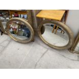 A PAIR OF OVAL GILT FRAMED MIRRORS