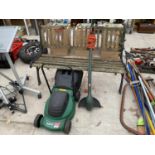 A GARDEN BENCH WITH CAST IRON ENDS, A QUALCAST ELECTRIC LAWNMOWER AND A STRIMMER