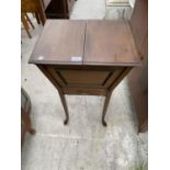 AN EDWARDIAN MAHOGANY PATENT (REG NO.473021) SEWING TABLE WITH LINED INTERIOR, FOLD-OVER TOP,