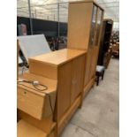 A RANGE ULFERTS BEDROOM FURNITURE COMPRISING A TALL STORAGE UNIT, TALL BOY, HEADBOARD AND CABINET