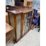 AN OAK CHINA CABINET WITH TWO GLAZED PANEL DOORS AND SIDE PANELS