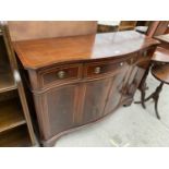 A REPRODUCTION MAHOGANY AND INLAID BOWFRONTED SIDEBOARD ENCLOSING THREE DRAWERS AND THREE