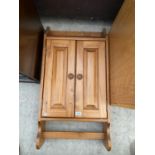 A MODERN TWO DOOR PINE WALL CABINET