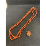 A CORAL DOUBLE ROW NECKLACE, LENGTH 47.2CM AND A VICTORIAN CORAL BROOCH