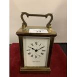 A BRASS MAPPIN AND WEBB CARRIAGE CLOCK WITH VISABLE MOVEMENTS AND KEY