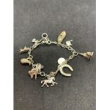 A SILVER CHARM BRACELET WITH TWELVE CHARMS