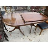 A REGENCY STYLE MAHOGANY TWIN PEDESTAL DINING TABLE WITH EXTRA LEAF