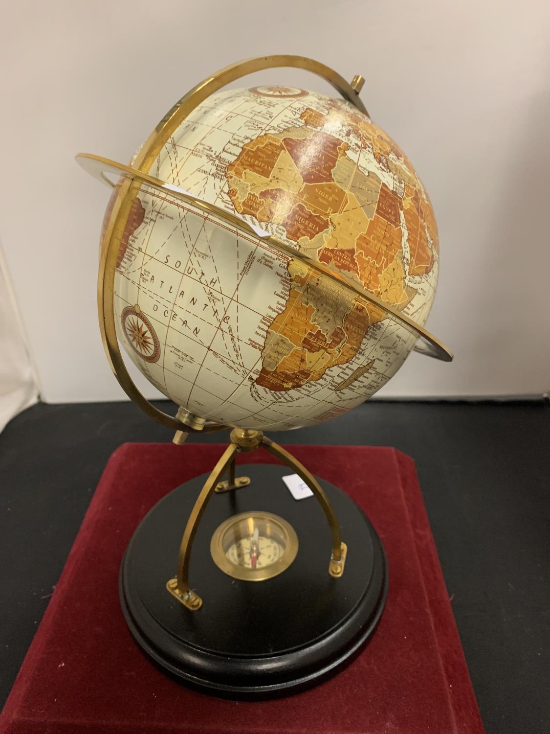 A GLOBE MOUNTED ON A WOODEN PLINTH INCORPORATING A COMPASS