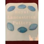 A PILKINGTONS LANCASTRIAN POTTERY CARD OF SIX BLUE GLAZED BUTTONS SHAPE 2760