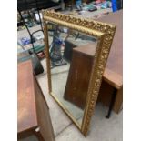 AN ORNATE GILT FRAMED MIRROR