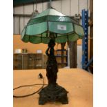 A METAL TABLE LAMP WITH A GREEN GLASS SHADE IN THE ART DECO STYLE