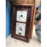 A WALL MOUNTED WOODEN BOXED CLOCK WITH ORNATE GLASS FRONT