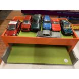 A WOODEN GARAGE WITH TOY CARS