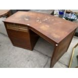 AN UNUSUAL MID CENTURY CURVED DESK WITH DROP DOWN ROLLER SHUTTER COMPARTMENT AND SHALLOW DRAWER -