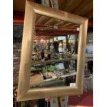 A MODERN PAINTED FRAMED MIRROR