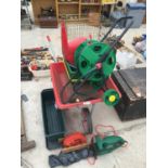 A WHEELBARROW, HEDGE TRIMMER, HOSE REEL AND VARIOUS GARDEN TOOLS