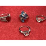 FOUR SILVER RINGS WITH VARIOUS STONES