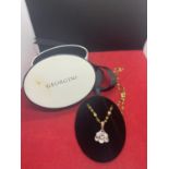 A BOXED YELLOW METAL CHAINED NECKLACE WITH A WHITE STONE PENDANT