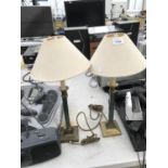 A PAIR OF BRASS TABLE LAMPS WITH CREAM SHADES