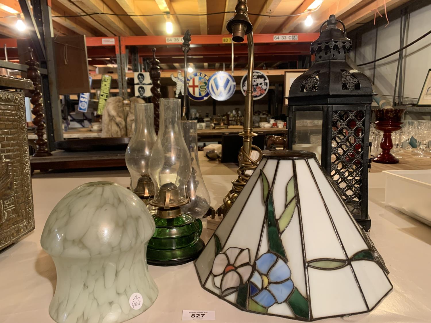 A GROUP OF TABLE LIGHTS TO INCLUDE A LARGE METAL CANDLE HOLDER AND TWO GLASS OIL LAMPS