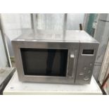 A SAINSBURYS MICROWAVE OVEN BELIEVED IN WORKING ORDER BUT NO WARRANTY