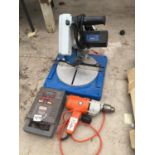 A BATTERY CHARGER, BLACK AND DECKER DRILL AMD AN ELECTRIC MITRE SAW