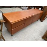 A G-PLAN STYLE TEAK SIDEBAORD WITH HAIRPIN LEGS, ENCLOSING THREE CUPBOARDS AND TWO DRAWERS, 72" WIDE