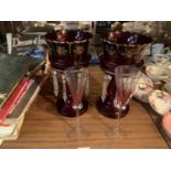 A PAIR OF CRANBERRY GLASS LUSTRES AND A PAIR OF PINK TINTED CHAMPAGNE FLUTES