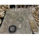 A LARGE ASSORTMENT OF GLASS WARE TO INCLUDE FIVE CUT GLASS DECANTERS AND NUMEROUS SERVING BOWLS ETC