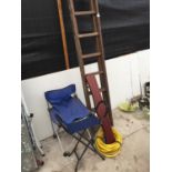 A WOODEN LADDER, TWO FOLDING SEATS, A ROLL OF PIPE AND A SHELF