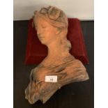 A TERRACOTTA BUST OF A YOUNGER FEMALE IN THE STYLE OF A GREEK GODDESS
