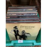 A LARGE ASSORTMENT OF VINTAGE RECORDS TO INCLUDE JOHN DENVER, THE WOMBLES AND FLEETWOOD MAC ETC