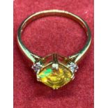 A 9 CARAT GOLD YELLOW STONE RING WITH DIAMONDS SIZE 0